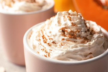 Cup with tasty pumpkin spice latte, closeup