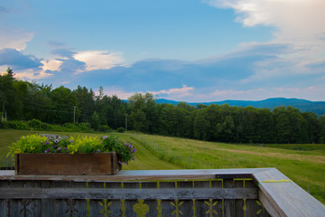 Fototapeta premium view from deck of beautiful mountains, fields, meadows, and sky