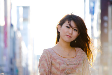 Japanese Girl poses on the street in Ginza, Japan. Ginza is a shopping city located in Tokyo.