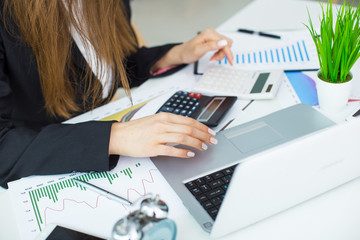 Image of young business woman working on project at office