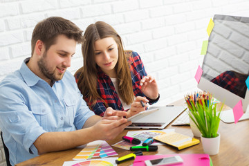 Team of creative designers working on a common project in a design studio