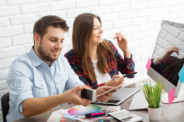 Team of creative designers working on a common project in a design studio