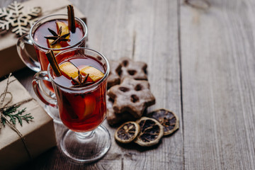 Christmas home atmosphere. Cozy and warming winter drink. Hot mulled wine, delightful festive sweets and gift boxes