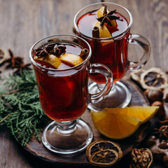 Christmas and New Year cozy holiday composition with hot mulled wine, traditional festive sweets and nuts . Winter holidays celebration concept