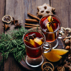 Winter holidays still life. Hot mulled wine, traditional gingerbread cookies and spices. Home...