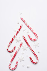Christmas tree decoration made of candies on white background. Creative, DIY, celebration concept