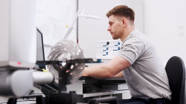 Male Engineer Uses CMM Coordinate Measuring Machine In Factory