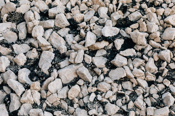 white stones of different shapes on black ground