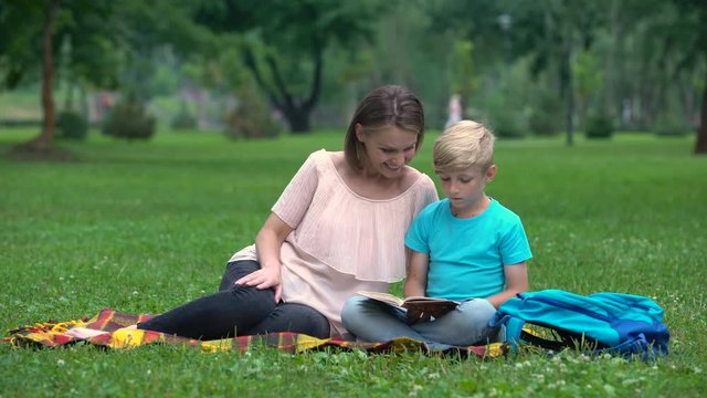 Teacher providing additional classes for junior pupil, individual tutoring