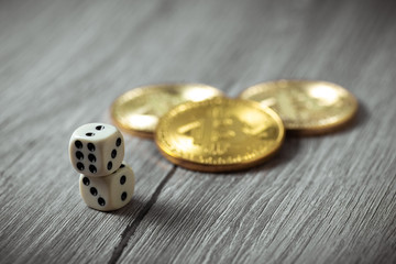 Bitcoins and dices on wooden background. Cryptocurrencie gambling concept