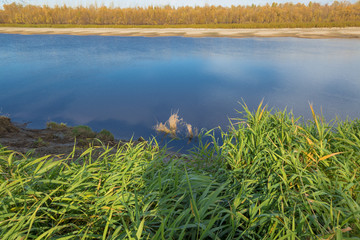 Steep and gently sloping bank of a wide river