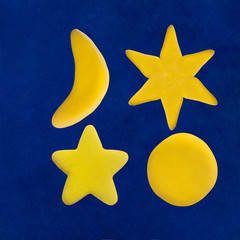 Plasticine star and moon on blue sky