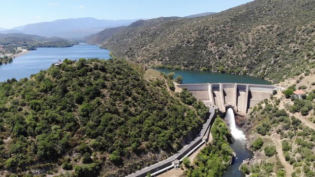 Aerial Drone Footage of Retenue de Vinca, a Lake in the Pyrenees-Orientales Mountains, with a Dam and the Chapel of St Pierre in the South of France