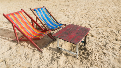 Red and Blue Beach Chair with Wood Table on The Beach