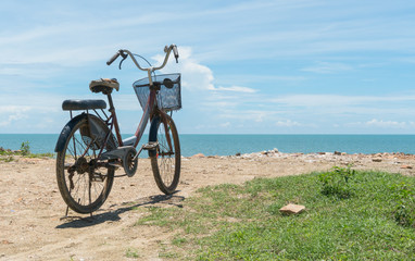 Fototapeta premium Red Bicycle on Beach and Blue Sky and Sea