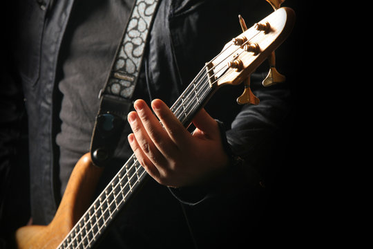 Close up young male guitarist playing guitar