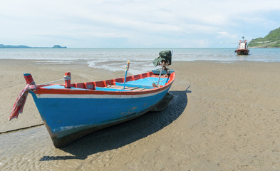Fototapeta na wymiar Blue Fishing Boat on Sam Roi Yod Beach Prachuap Khiri Khan Thailand Left 3