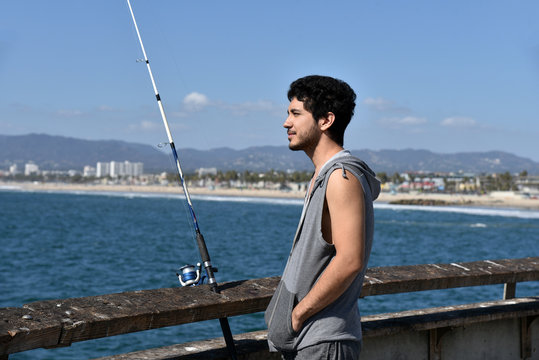 Handsome Young Man On A Fishing Pier