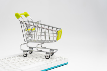 Close up of supermarket grocery push cart for shopping with black wheels on white background....