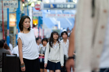 Japanese Girl poses on the street in Yokohama, Japan. Yokohama is a port city located in a bit south of Tokyo.