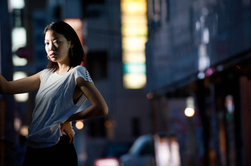 Japanese Girl poses on the street in Yokohama, Japan. Yokohama is a port city located in a bit south of Tokyo.