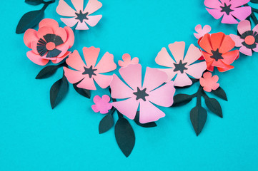 Flower and leaves of paper turquoise background