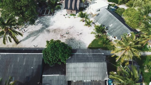Top view. Kids playing football on courtyard in small village. Thailand - Moken