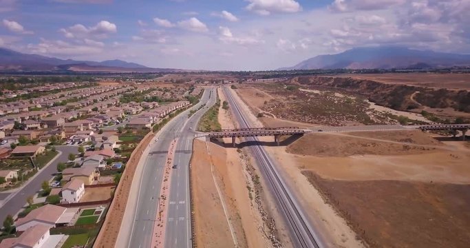 Train birds eye view, blue sky with mountains. 4k dci