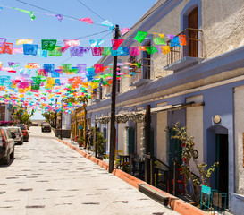 Colorful Mexican flags over street (papel picado)