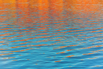 Obraz premium Fall season outdoor background, colorful trees reflect in the water