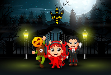 Happy kids wearing halloween costume outdoors at night