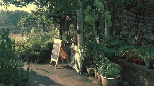 Lady opening up cafe for business in the morning on a sunny day