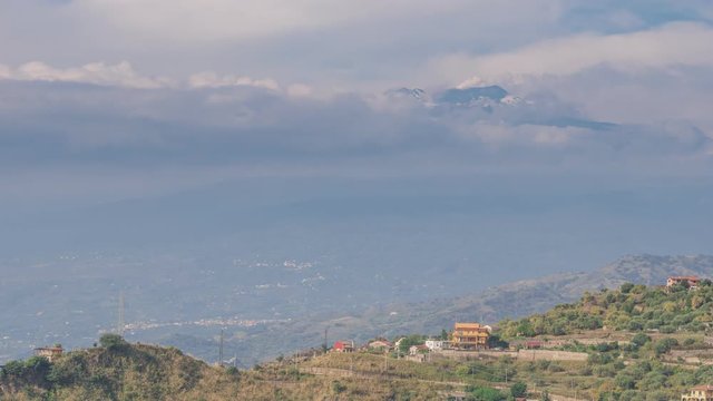 Aerial time lapse just above the clouds of the Volcanic Mount Etna Venting Steam and Smoke