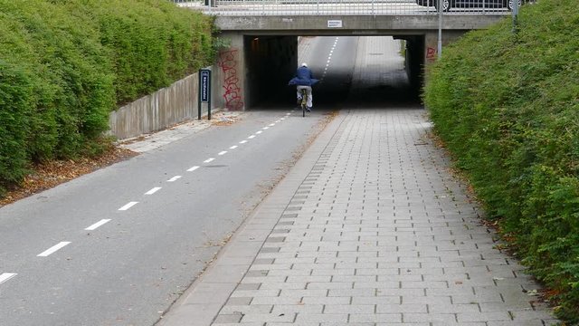 Bicycling through tunnel in the city.