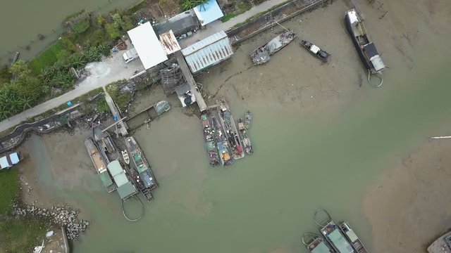 Boat mooting to a pier on a polluted river in asia