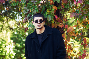 portrait of a young man in the autumn Park