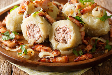 Cepelinai dumplings are made from grated and riced potatoes and stuffed with ground meat. National dish of Lithuania. Horizontal © FomaA