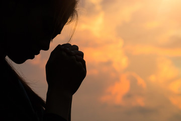 Silhouette of woman hands praying to god with the bible. Woman Pray for god blessing to wishing have a better life. Christian life crisis prayer to god. - obrazy, fototapety, plakaty