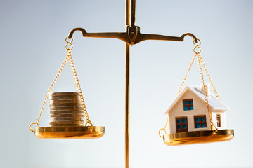 Stacked Coins And House Model Balancing On Justice Scale