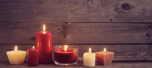 red and white candles on dark wooden background