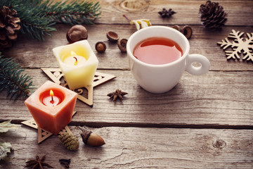 candles and Christmas decoration on wooden background