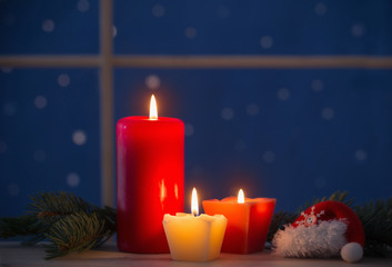 Christmas candles on background night window