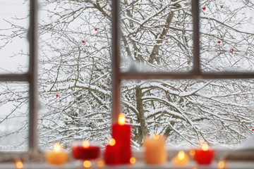 burning candles on a windowsill