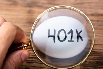 Person Examining 401k White Egg