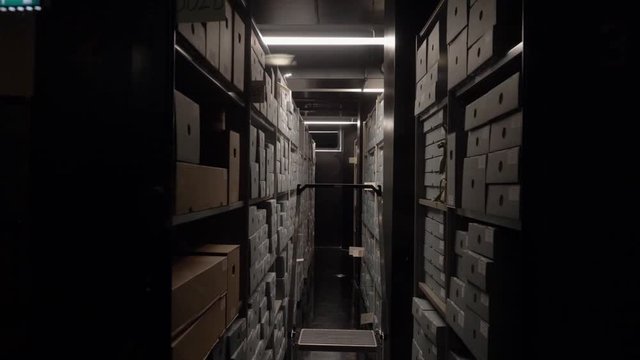 A pan revealing archive shelves, full of boxes and papers. In the Bazel, Amsterdam, the Stadsarchief.
