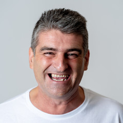 Obraz premium Close up portrait of a smiling and laughing mature man in happy face human emotions and expressions