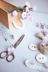 Vintage background, hand made. Old scissors, ribbons, wooden buttons, a notebook for text and flowers.