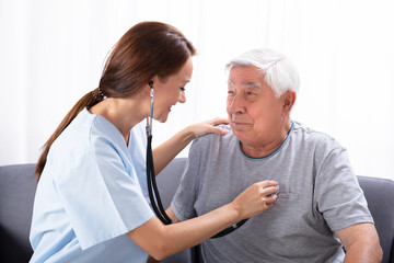 Nurse Examining Senior Man With Stethoscope