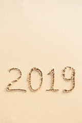 New Year 2019 handwritten on the sandy beach