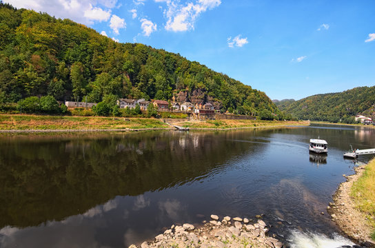 Elbe River in the Bohemian Switzerland National Park. Small white ferryboat connects the Czech Republic and Germany. Famous touristic place and travel destination in Europe. Hrensko, Cech Republic